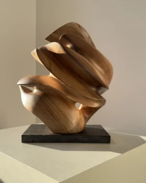 aperture-abstract-walnut-wood-sculpture-front-view-1 Front View Aperture abstract walnut wood sculpture on black granite base in warm natural light