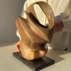aperture-organic-walnut-sculpture-scale-detail Natural light passing through the carved openings of Aperture walnut sculpture