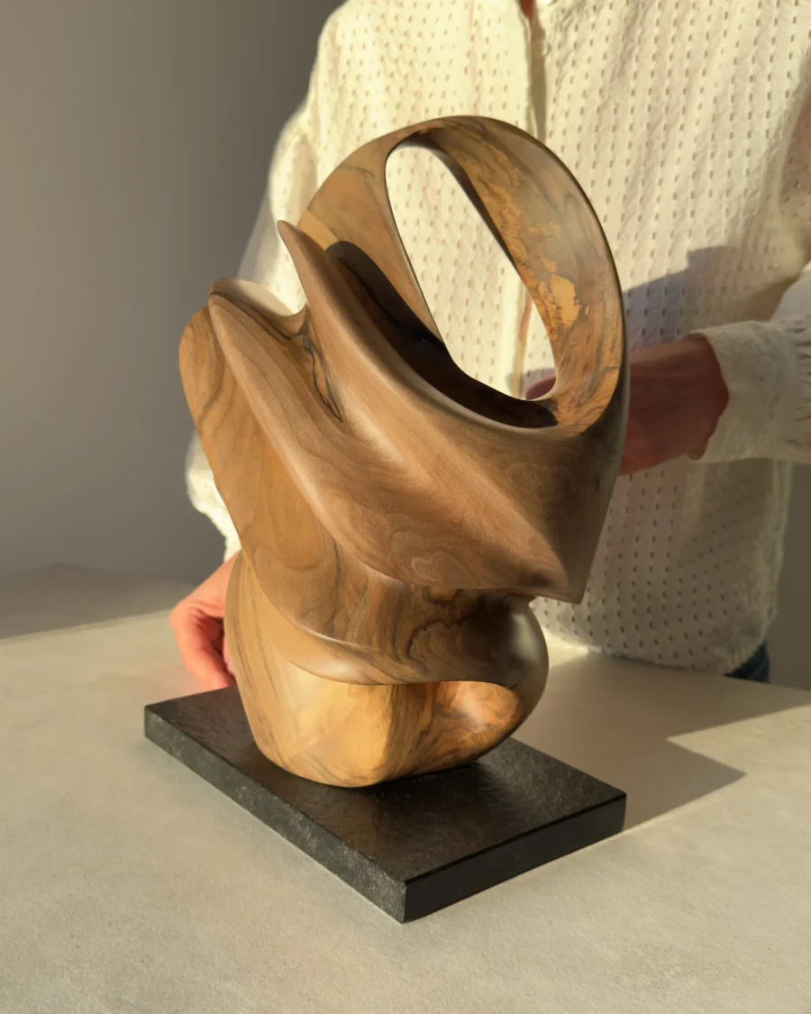 aperture-organic-walnut-sculpture-scale-detail Natural light passing through the carved openings of Aperture walnut sculpture