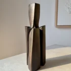 Three-quarter view of Counterpoise organic modern wood vase showing how its three asymmetrical supporting forms change from different angles.