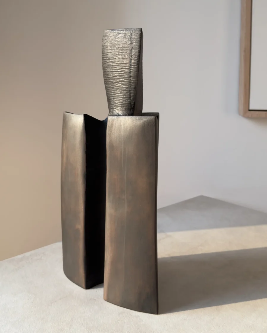 Rear view of Counterpoise sculptural pear wood vase showing the relationship between its central textured axis and two curved outer forms.