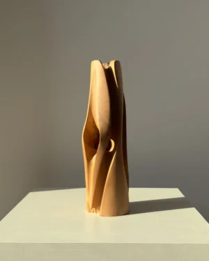 Side view of the Hidden Heart cherry wood vase showing the small opening that reveals its hidden inner chamber.