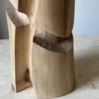 Detail of the hand-carved surfaces and natural walnut grain on the Knot wooden vase.