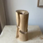 Three-quarter view of Knot sculptural walnut wood vase showing its organic carved geometry.