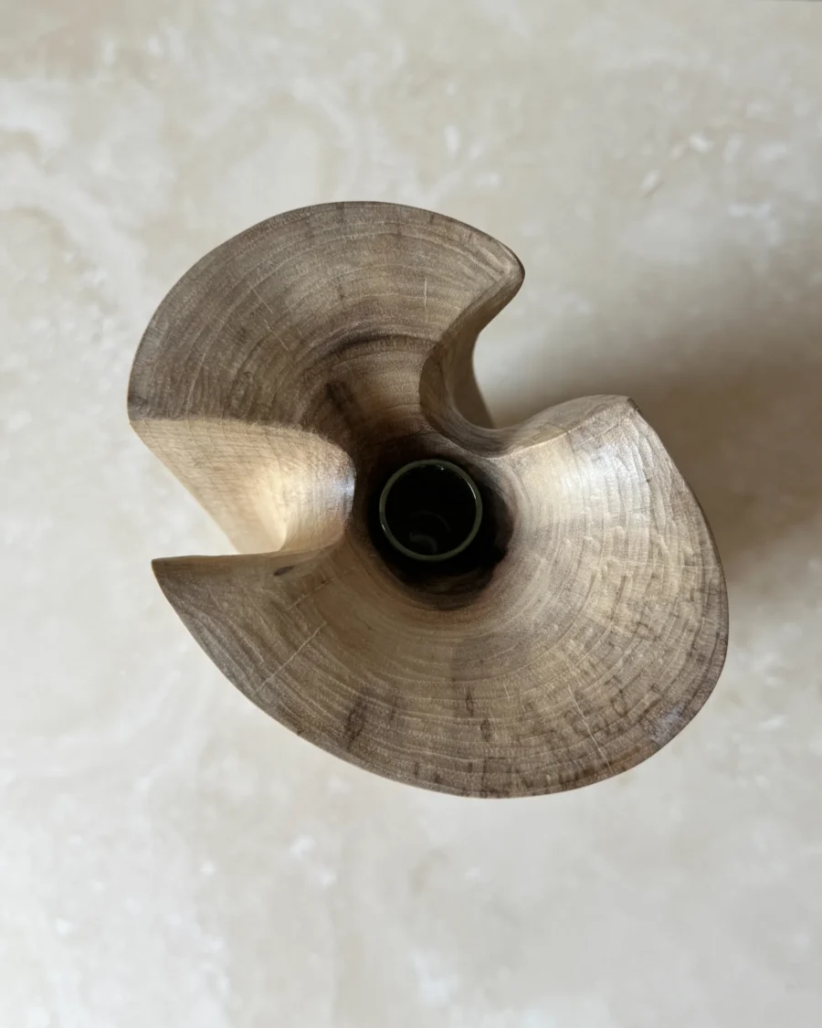 Top view of Knot hand-carved walnut wood vase showing the sculpted opening and removable glass tube.