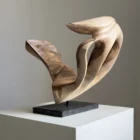 becoming-abstract-walnut-sculpture-open-form Three-quarter view of Becoming showing its sweeping organic walnut forms, carved openings and dramatic transitions between pale and dark wood.