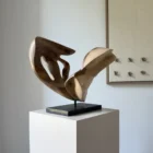 becoming-modern-walnut-sculpture-interior-view Becoming shown with its darker walnut side facing forward, revealing two elongated openings and the contrast between heartwood and pale outer wood.