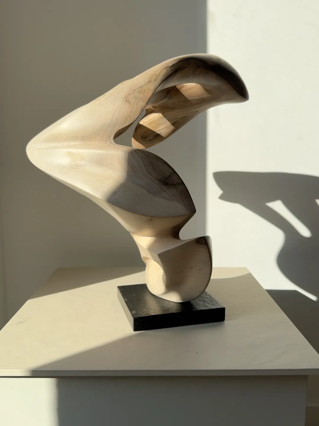 Side view of Becoming in its earlier vertical orientation, revealing the curved profile and changing balance of the form.