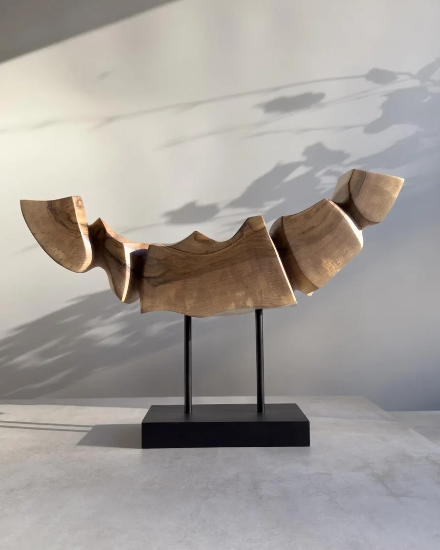 Side perspective of Dynamic Contours showing the flowing carved planes, angular transitions and natural walnut grain.