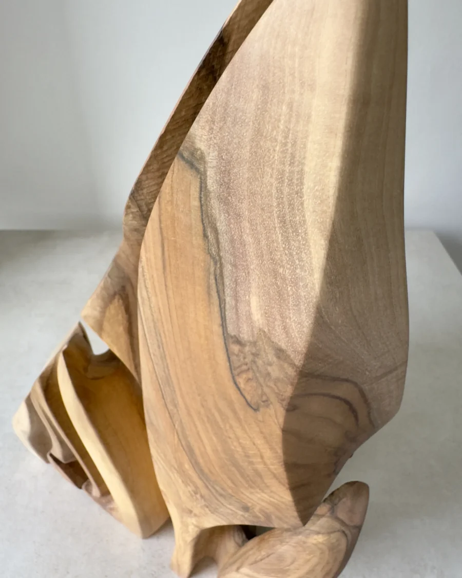 Detail of the hand-carved forms and natural grain transitions in Flowing Unity