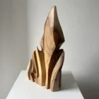 Profile view of Flowing Unity with curved walnut forms opening narrow spaces for light
