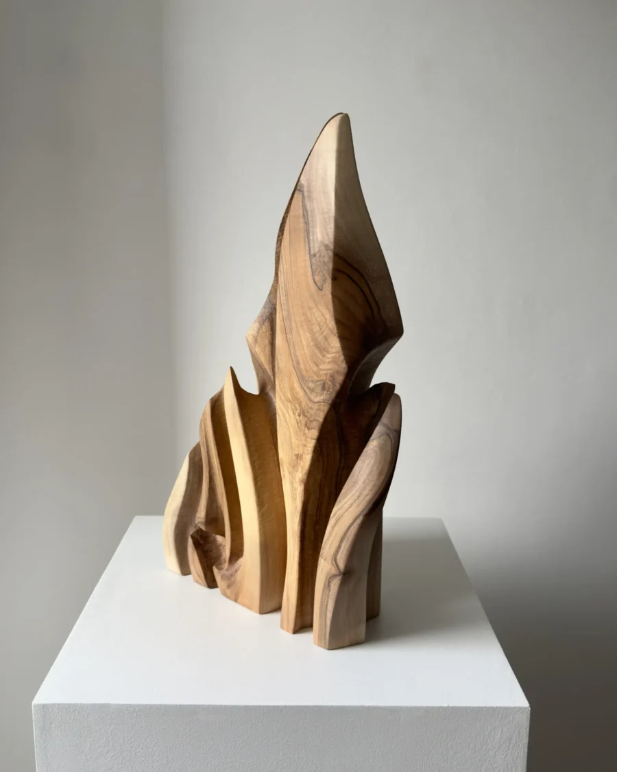 Profile view of Flowing Unity with curved walnut forms opening narrow spaces for light