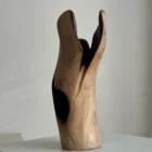 Rear view of Hollow walnut wood vase highlighting the uninterrupted natural grain and softly curved carved surface.