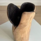 Close view of Hollow walnut sculptural vase showing the deep charred interior, hand-carved texture and smooth natural wood exterior.