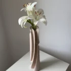 Rear three-quarter view of Hush revealing layered carved lines, subtle tool texture and the natural grain beneath the pale finish.