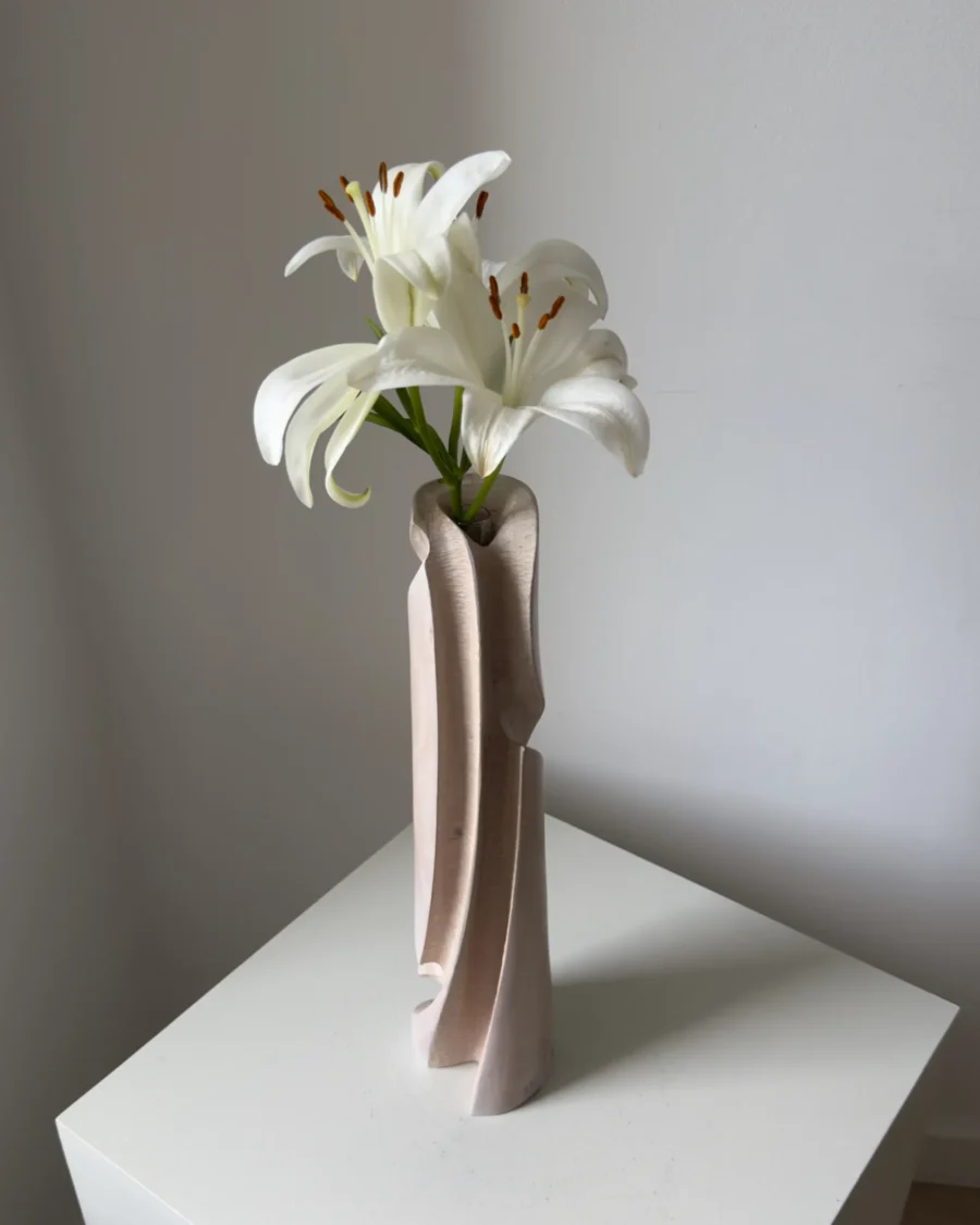 Rear three-quarter view of Hush revealing layered carved lines, subtle tool texture and the natural grain beneath the pale finish.