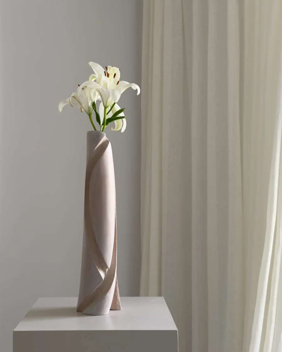 Side profile of the Hush sculptural vase with a sweeping carved edge and softly muted apple wood grain.