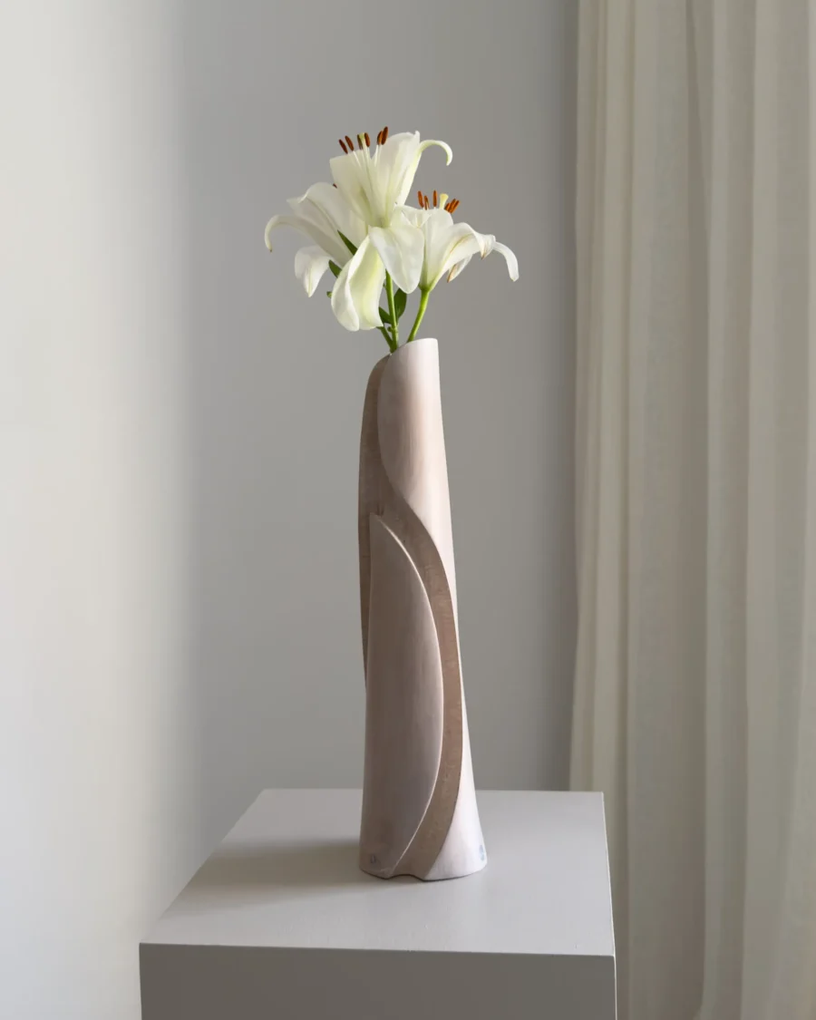 Rear view of Hush showing the vertical carved movement, tapered shape and subtle variations in the white-waxed apple wood.