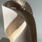 Detail of Hush showing the removable glass tube, fresh lily and hand-carved texture inside the pale recessed surface.