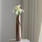 Angled view of Hush highlighting the deep sculptural cuts, pale finish and organic movement of the hand-carved apple wood.