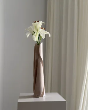 Angled view of Hush highlighting the deep sculptural cuts, pale finish and organic movement of the hand-carved apple wood.