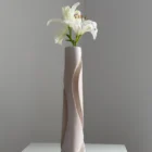 Hush sculptural wood vase from another angle, revealing the deep carved channel and changing planes of the apple wood form.