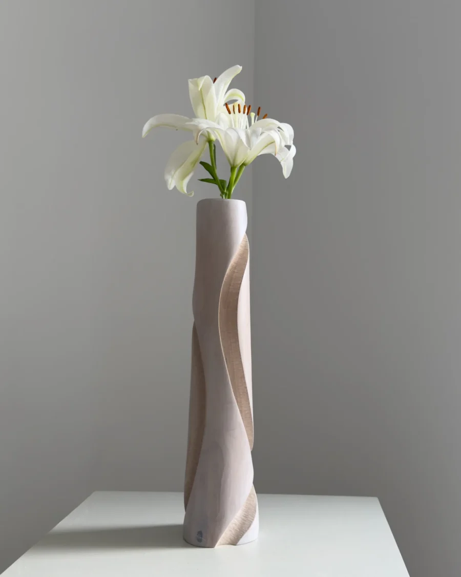 Hush sculptural wood vase from another angle, revealing the deep carved channel and changing planes of the apple wood form.