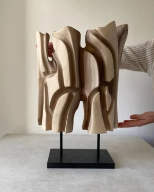 Interstice hand-carved abstract wood sculpture with flowing openings and black granite base, front view