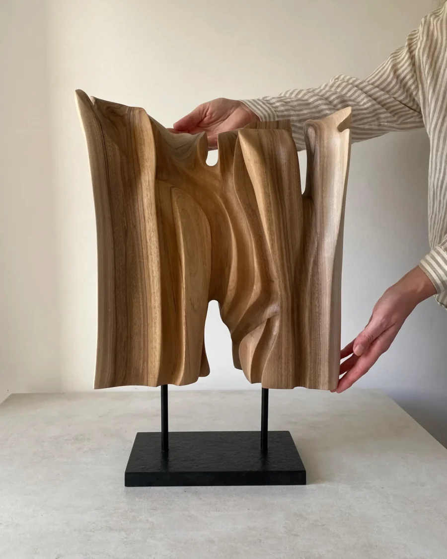 Reverse view of Interstice hand-carved wood sculpture with vertical carved forms and open spaces