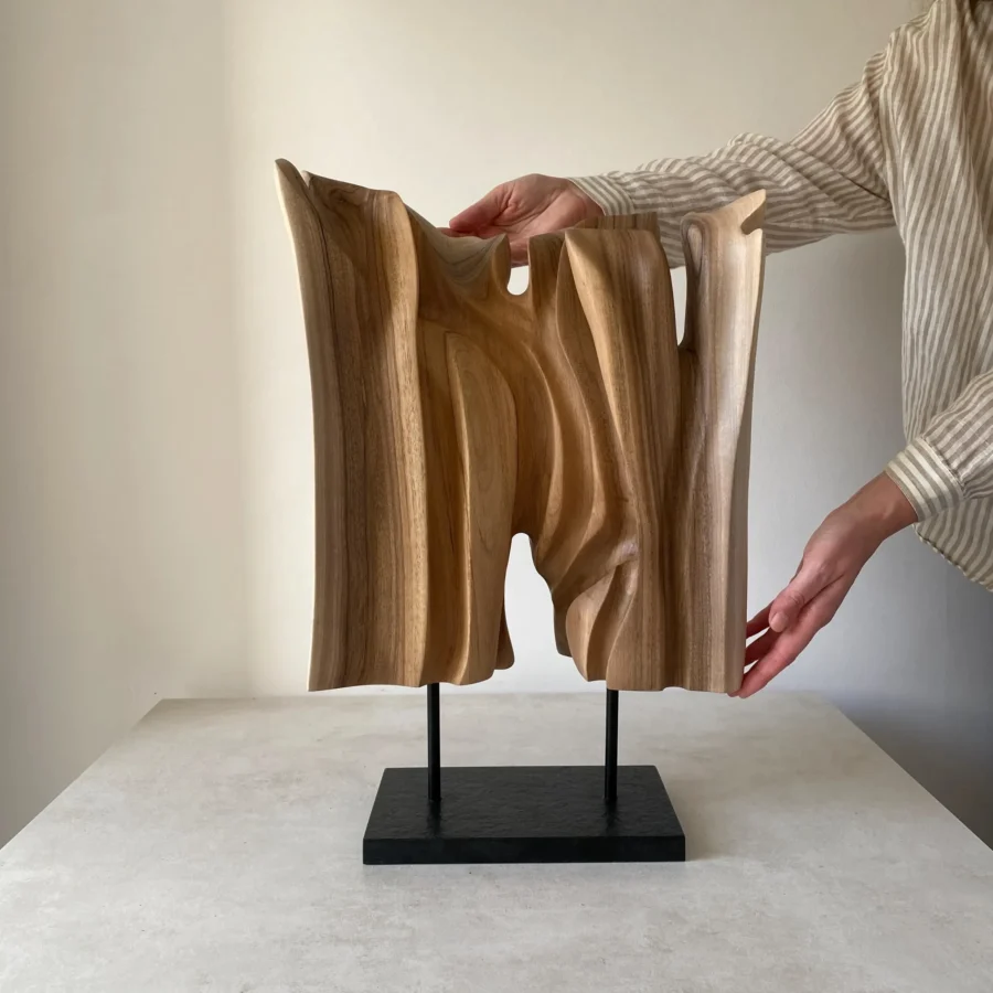 Reverse view of Interstice hand-carved wood sculpture with vertical carved forms and open spaces