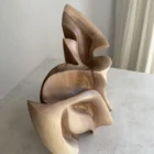 Top view of Unfurl abstract walnut sculpture, showing the layered composition, carved recesses and natural grain across the flowing form.