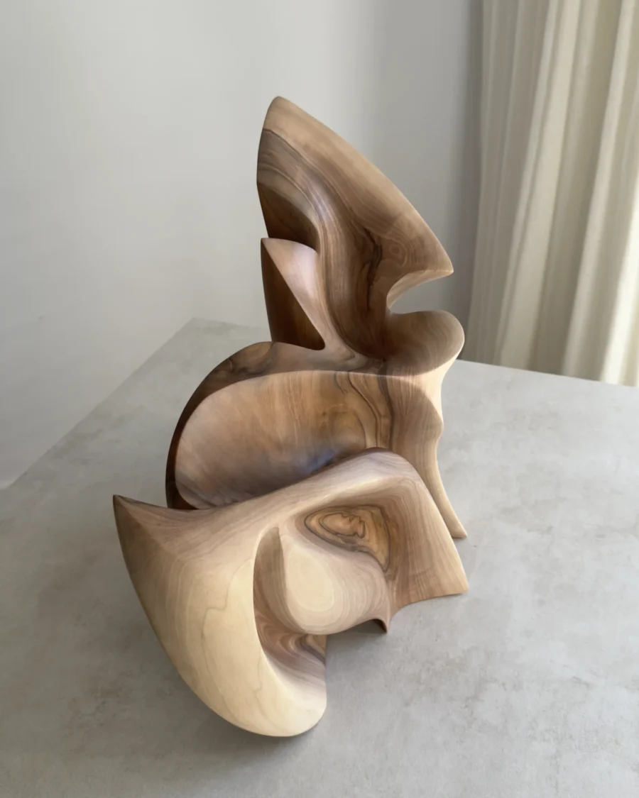 Top view of Unfurl abstract walnut sculpture, showing the layered composition, carved recesses and natural grain across the flowing form.