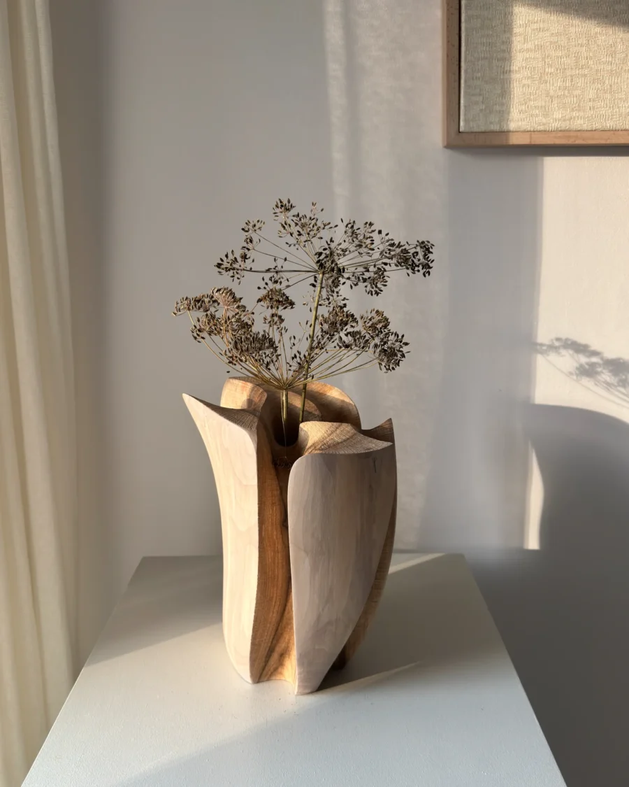 Within from the opposite side with dried stems, showing how sunlight changes the colour and depth of its carved walnut surfaces.