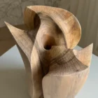 Top view of Within revealing the central opening, radiating tool texture and swirling walnut grain inside the carved form.