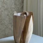 Rear view of Within with broad smooth walnut surfaces, narrow dark recesses and an irregular sculptural rim.