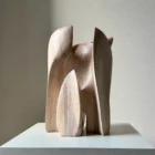 Embrace abstract walnut wood sculpture, hand-carved with flowing organic forms surrounding an open centre