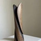 Front view of Emergence with white gypsophila, the flowers emerging between two elongated smooth cherry wood planes.