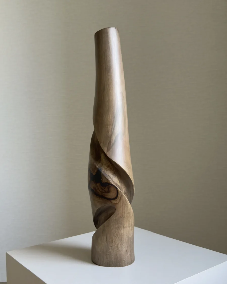 quiet-turn-walnut-sculptural-vase-main-view Quiet Turn one-of-a-kind walnut sculptural vase, showing the black resin detail, flowing carved cuts and softly toned smooth surface.