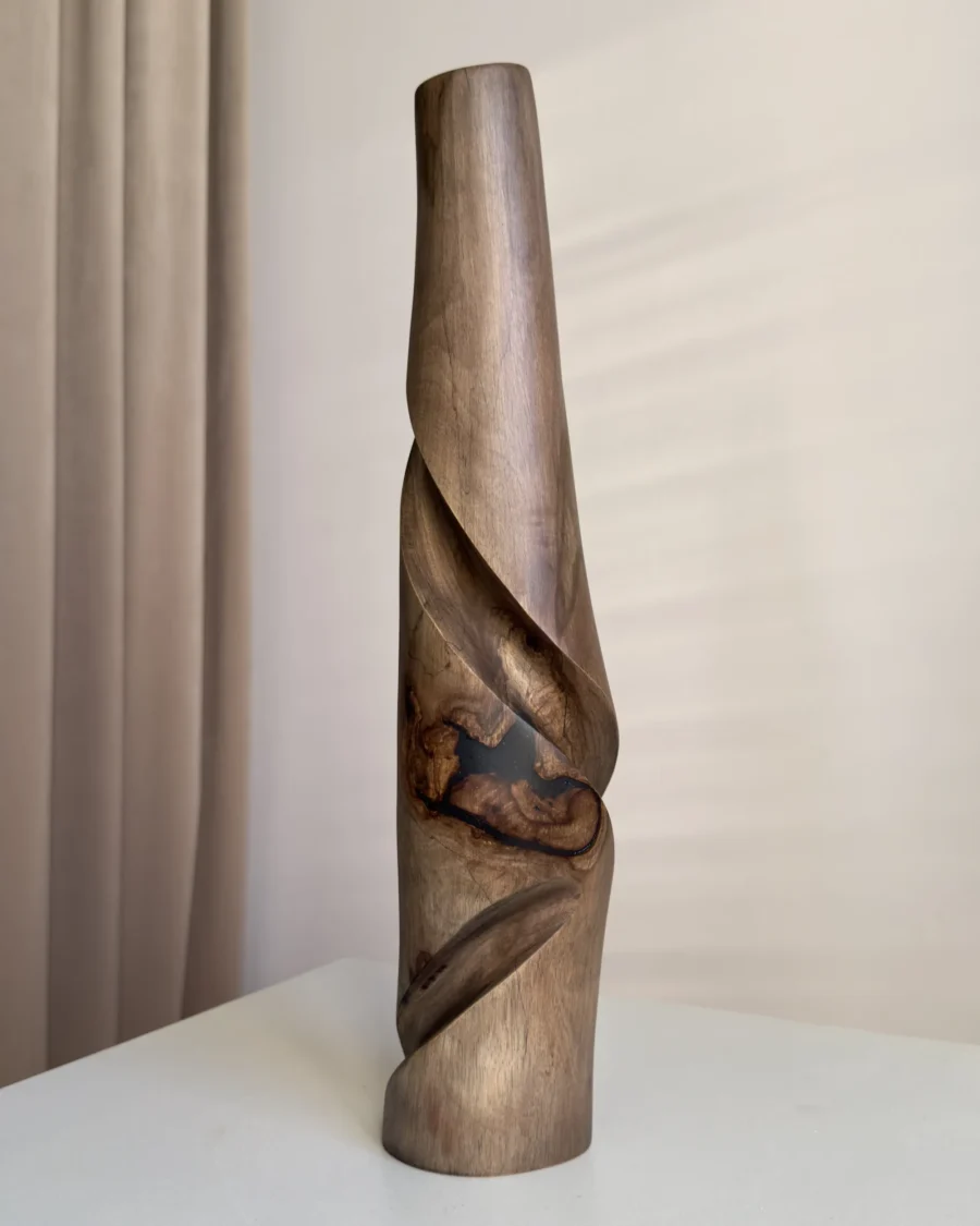 quiet-turn-walnut-vase-black-resin-detail Front view of Quiet Turn showing the black resin inclusion, natural walnut grain and carved diagonal forms.