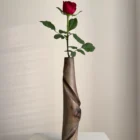 quiet-turn-walnut-vase-red-rose-front-view Tall walnut wood vase Quiet Turn with a red rose, showing its slender sculptural form and carved diagonal movement.