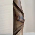 quiet-turn-walnut-vase-resin-close-u Close-up of the central black resin inclusion in Quiet Turn, surrounded by natural walnut grain and smooth hand carved surfaces.